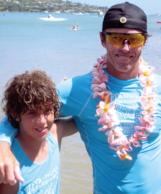Champion paddleboarder Chris Owens with his son C.J. after the final leg of a Molokai channel race. Photo from Catherine Lo. See story on page 6.