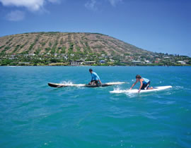 Chris Owens with son C.J. paddle as a team in the 10th annual Quiksilver edition Molokai to Oahu Paddleboard Race. Photo from Catharine Lo.