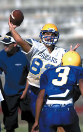Cougar quarterback Skylar Chan grips the ball. Photo by Byron Lee, staff photographer.