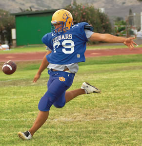 Kyle Niiro shows his stellar kicking style on the Kaiser field. Photo by Nathalie Walker