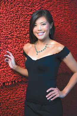 Stephanie Lum shows off an Afghan emerald necklace and earrings donated by The Gem Hunter.