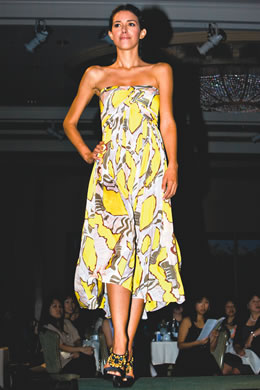 Dani Andrade: Emilio Pucci yellow print strapless dress $1,495, Luxury Rebel brown sandal with yello