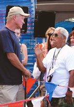 Vans Triple Crown director Randy Rarick (left) talks with legendary Rabbit Kekai at the opening of the OP and Roxy Pro
