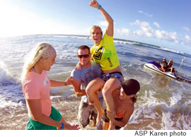 Chelsea Georgeson (Australia) is carried up the beach by her fiance Jason and friend Trudy Todd after she clinched the Roxy Pro title in Haleiwa. Georgeson posted a perfect 10 points
