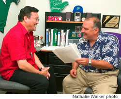 In his role as a consultant, Kimo confers with Chris Hart, KKEA program/operations manager