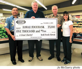 From left: Gerald Shintaku, Kraft Foods Hawaii business manager; Dick Grimm, Hawaii Foodbank president; Roger Godfrey, Times Super Market president, and Sweetie Pacarro, Kraft Foods Hawaii spokeswoman with a for the Hawaii Foodbank as part of Kraft’s Check Out Hunger campaign