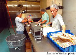 Pacita Cabreros, Orbela Javier and Mellissa Dela Cruz pack freshly baked tortillas for shipping