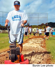 Corey Ishigo and his players work to improve the Kailua High Field