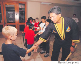 Student Jackson Welter shakes hands with the grandmaster in a show of teamwork and sportsmanship