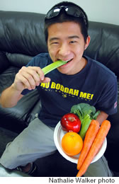 Micah Kagihara munches on a celery stick because studies have shown that eating five servings of different vegetables and fruits per day reduces the risk of developing cancer