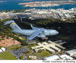 A C-17 flies over Hickam AFB, it’s new home in the Pacific