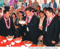 (from left) Keith Lim, Leslie Young and Cy Feng make an offering to the ancestors at last year’s Qing Ming celebration