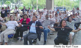 State health director Dr. Chiyome Fukino (far right) and DOH employees do the Rubber Band Man strength and resistance exercise