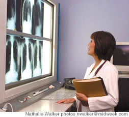 Dr. Christine Fukui reviews X-rays of lungs at Kaiser-Moanalua