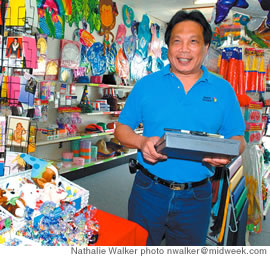 Party Pizzazz owner Bennett Chan happily fills his store with the essentials needed for a fun party