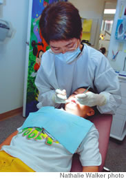 Dr. Loo checks Austin Torralba’s teeth