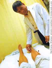 Acupuncturist Shi Zhong Xiao puts needles on a patient. He will be at the Splendor of China this weekend at the Neal Blaisdell Center