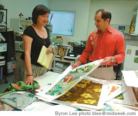 Feldman with art coordinator Amy Renshaw reviews art designs