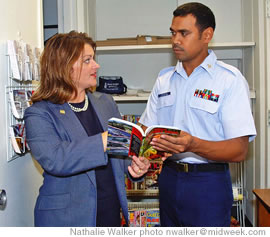 USO Hawaii director Cassandra Isidro helps Klaudio Idelbong of the Coast Guard with activities available in Honolulu