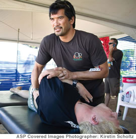 Dr. Leland Dao works on world No. 2-ranked surfer Mick Fanning at the Op Pro at Haleiwa