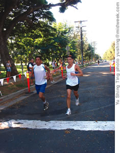 Jeff Lim and Jonathan Lyau cross the finish line at the Turkey Trot