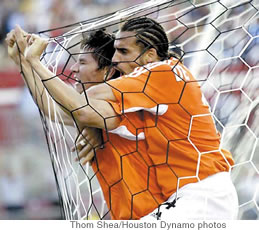 Dwayne De Rosario hugs Ching, who celebrates one of his four goals during Houston’s 2006 home opener against the Colorado Rapids in April