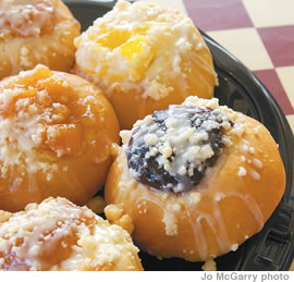 Freshly baked, fruit-filled kolaches. Peaches, apple and a variety of other flavors are topped with a drizzle of warm icing sugar and served up hot