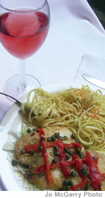 Mahimahi Picatta ia served with a light wine and caper sauce over spaghetti