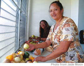 Joanne Enaena (in the foreground) and Zalei Kamaile in the kitchen at the Hope For a New Beginning Shelter in Kalaeloa