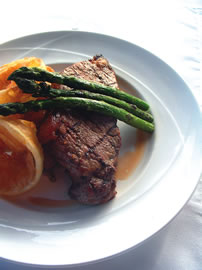 Grilled prime New York steak with grilled asparagus and Maui onion chips at Aaron’s Restaurant