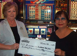 Zenaida Andres (right) of Lahaina is awarded a check for $50,000 at the Fremont