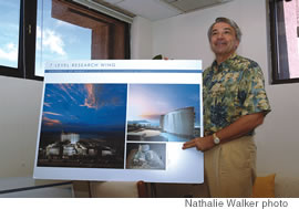 Carl-Wilhelm Vogel with a rendition of the planned Cancer Research Center of Hawaii in Kakaako
