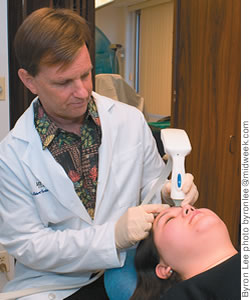 Dr. Robert Peterson performs a skin-smoothing procedure on a patient