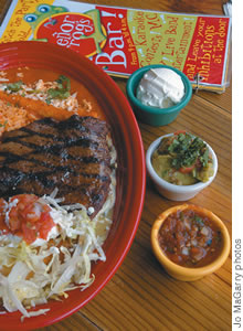 Combination Steak Plate features skirt steak, poblano peppers, refried beans, Mexican rice