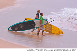 Robby Naish and Aaron Napoleon head out into the surf