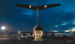 A crew loads up a massive C-17 Globemaster transport plane