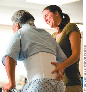 Physical therapist Holly Kincaid assists a patient with major multiple trauma