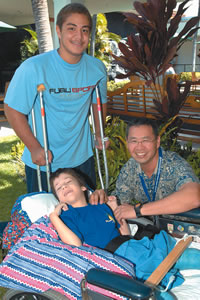 Dr. Craig Ono with patients David Eserona (standing) and Darrick Willis