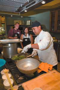 Brian Sheldon and Vickie Aquino-Jackson learn from Chef Elmer