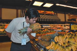 Chang says to pick up the pineapple and smell it for sweetness