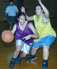 Lindsay Cartwright dribbles past Kaiona Auyong during a recent basketball practice at Pearl City High School. Photo by Byron Lee, staff photographer.