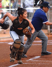 Campbell High School’s Anu Yamaguchi races to first base with umpire Walter Yamatsuka in the background. Campbell won 10-0 in the Nov. 29 game against Pearl City High. Photo by Nathalie Walker, staff photographer.