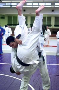 Pearl City High School junior Christian Pavo, a black belt in judo, throws 10th grade brown belt Justin Leong. Photo by Byron Lee
