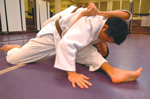Andy Toyama throws Aaron Puahala for a loop during Pearl City High School's judo practice.