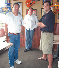 The owners of the new Ruby Tuesday in Windward Mall (from left) Rick Nakashima, Ted Davenport and Will Keliinoi, take a break from pre-opening preparations. Photo by Nathalie Walker