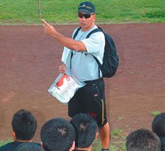 Coach Nelson Maeda gives his Castle football squad some preseason pointers. Photo by Nathalie Walker, staff photographer.