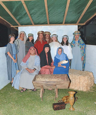 Participating in a live Nativity scene at the Dec. 6 Castle Medical Center tree-lighting festivities are (standing) CJ Fant, Russell and Joanne Barshaw, Craig Metcalf, Steve Higashi, Emily Metcalf, Sierra Falau and Ted Tengan, (sitting) Jon Barshaw, DeWayn and Laurie Sorrells. Photo by Nathalie Walker