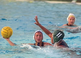 Castle’s Alex Connelly prepares to get the ball past Kayla Ponce of Aiea. Photo by Byron Lee