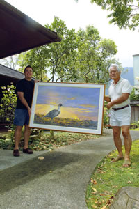 Hiroshi Tagami and Michael Powell carry a painting as they prepare for the grand reopening of their Lamaula Road gallery. Photo by Nathalie Walker