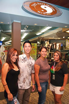 Lacey Skaggs, Kristian “Koko” Kukonu, Jessica Kauhane and Tracy Bjorken welcome customers to the newly renovated and expanded T&C Surf store at Windward Mall. Photo by Leah Ball.